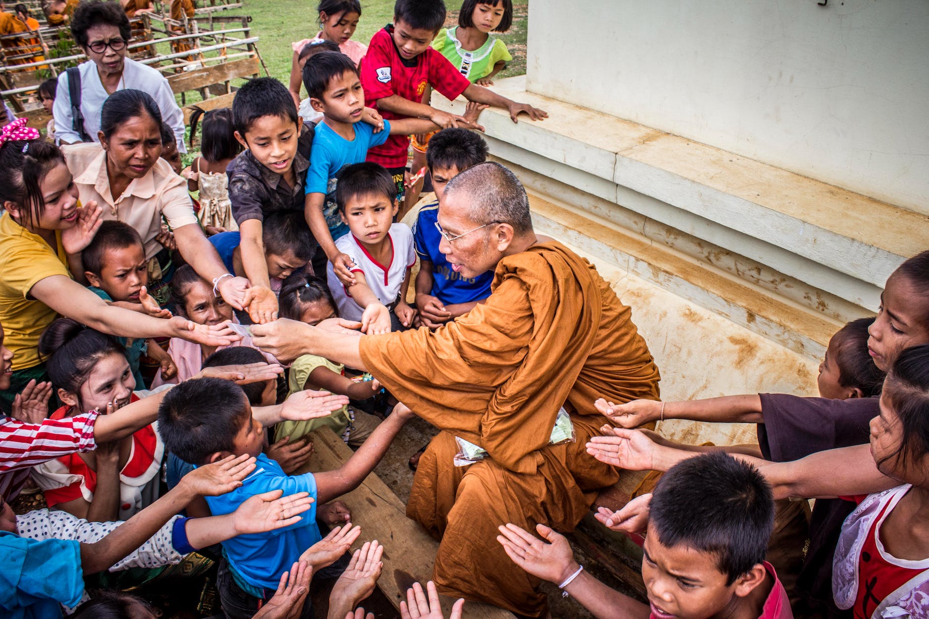 monk surrounded by children