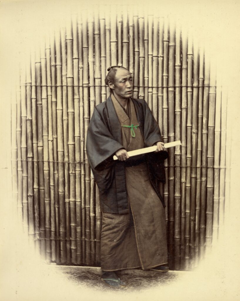Full length portrait of a man holding a rod