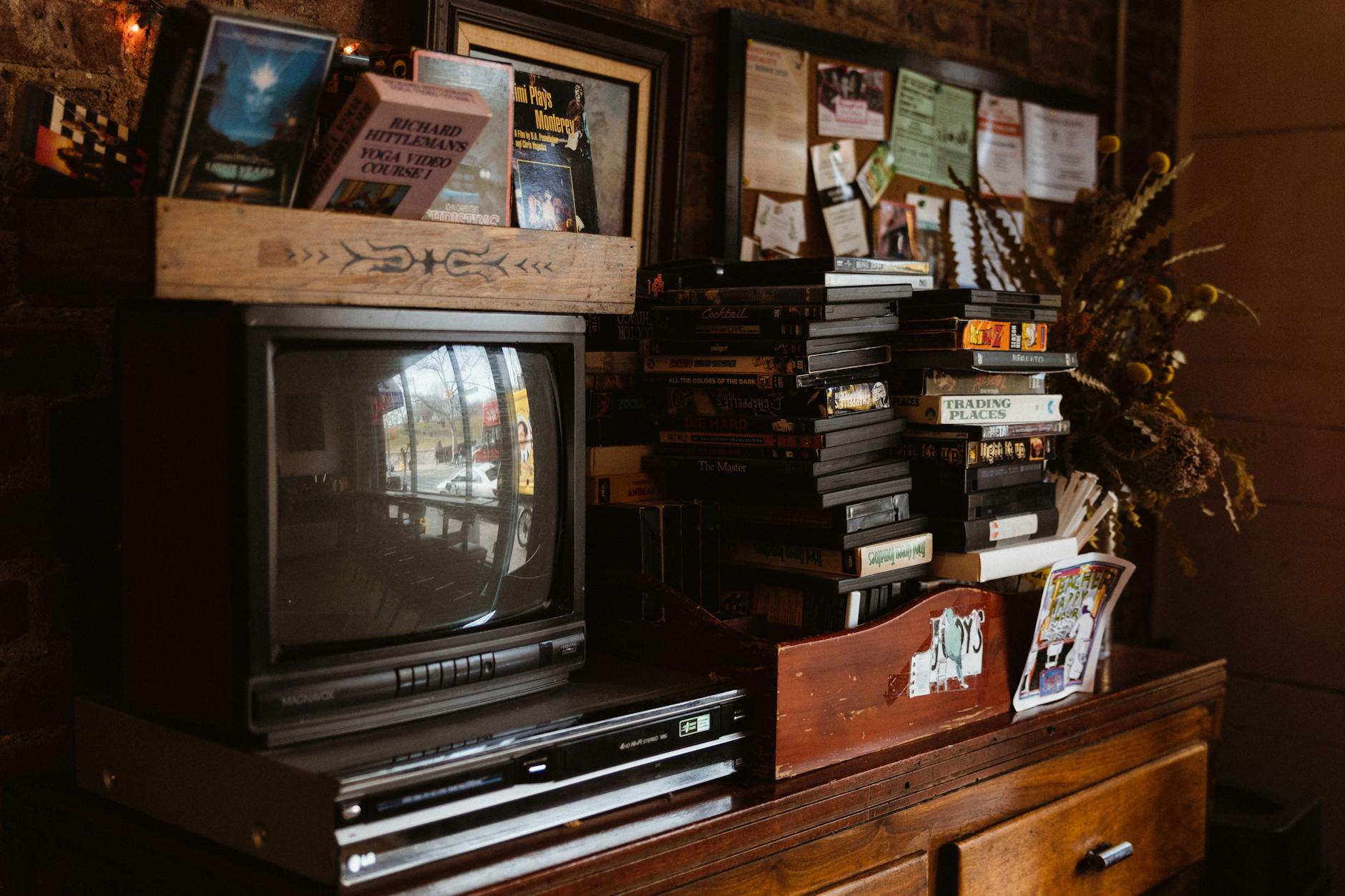 photo of a vintage tv dvd player tapes and cassettes on a vintage cabinet