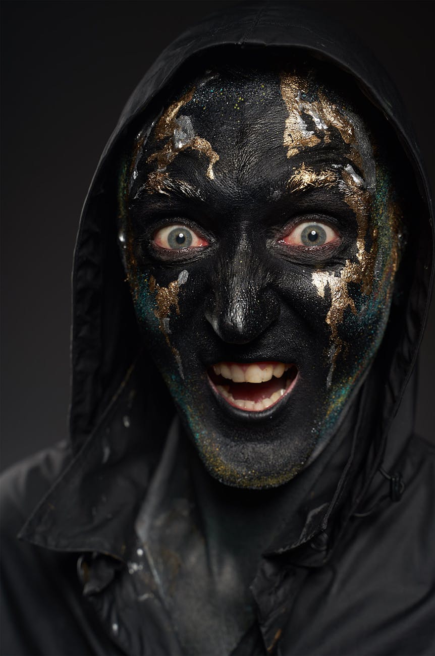person in black and golden face mask