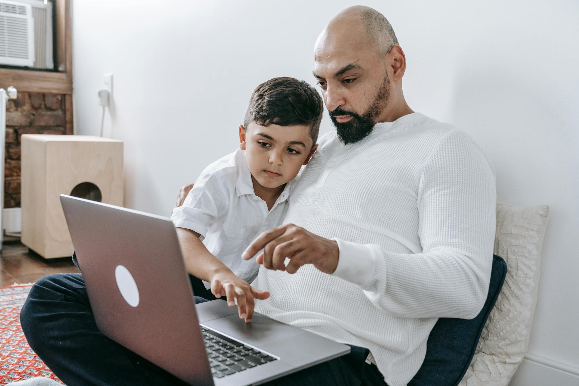 father and son sitting on the floor
