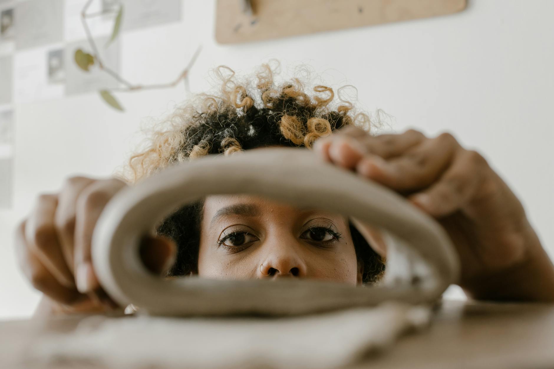 a close up shot of a woman molding a clay